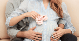 maternity photo with baby shoes