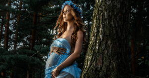 pregnant woman in an elegant flowing dress outdoors