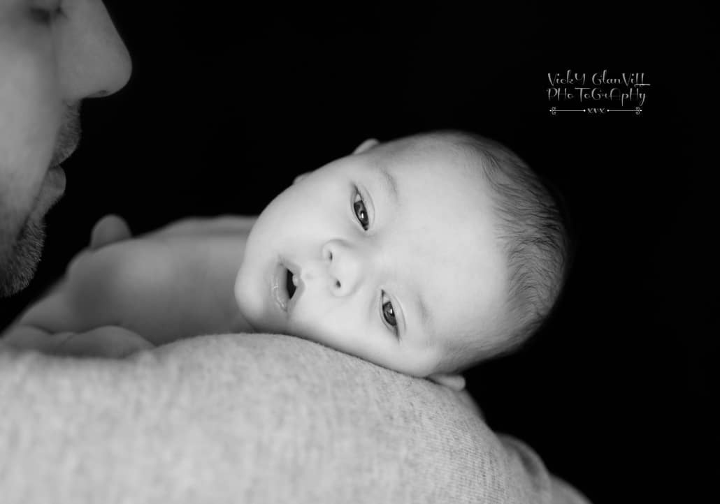 sleepy baby on parents shoulder